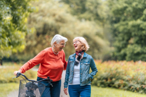 Two friends laughing together in a park
